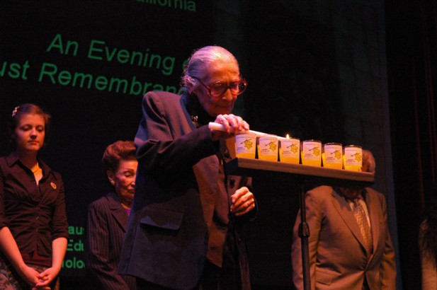 man lighting candle on stage