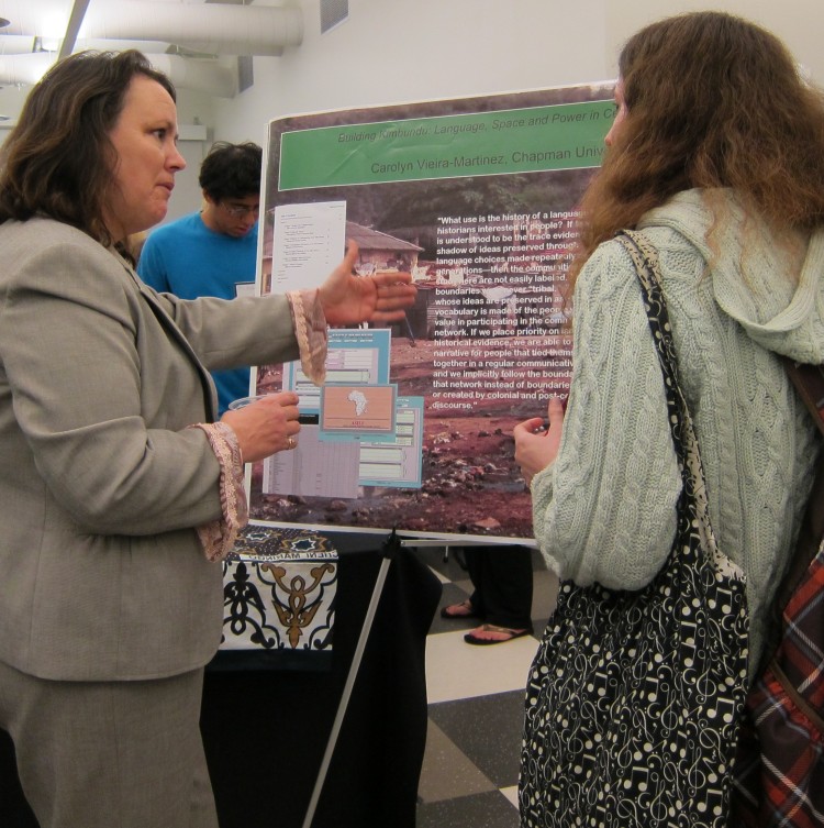 Carolyn Vieira-Martinez, assistant professor in the Department of History and a specialist in African history and language, explains her research to a student during 2011 Faculty Research Expo.