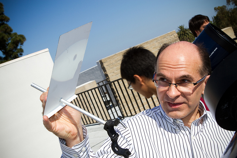 Professor Eric Minassian projects the Venus transit on white cards atop Hashinger Science Center Tuesday.