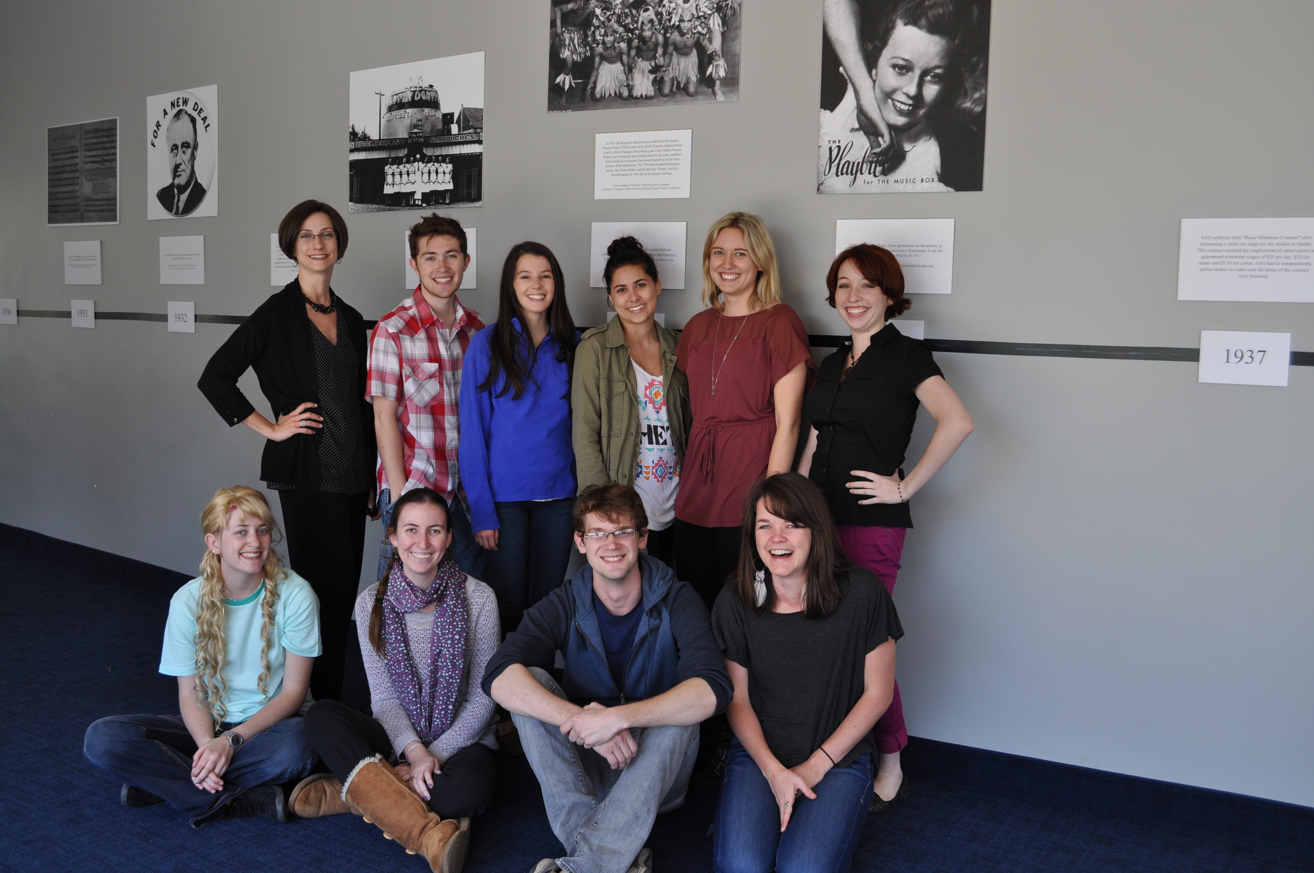Audiences attending "Stage Door" will be greeted by a lobby display timeline created by the dramaturgy class taught by Jocelyn L. Buckner, Ph.D., assistant professor. Pictured are, back row, left to right, Professor Buckner, Peyton Ashby, Jessica Mason, Gabbie Boyadjian, Britt Keller and Robyn Mack. Front row, left to right, are Brynn Nelson, Isabelle Grimm, Colby Sostarich, Jenna Selby.