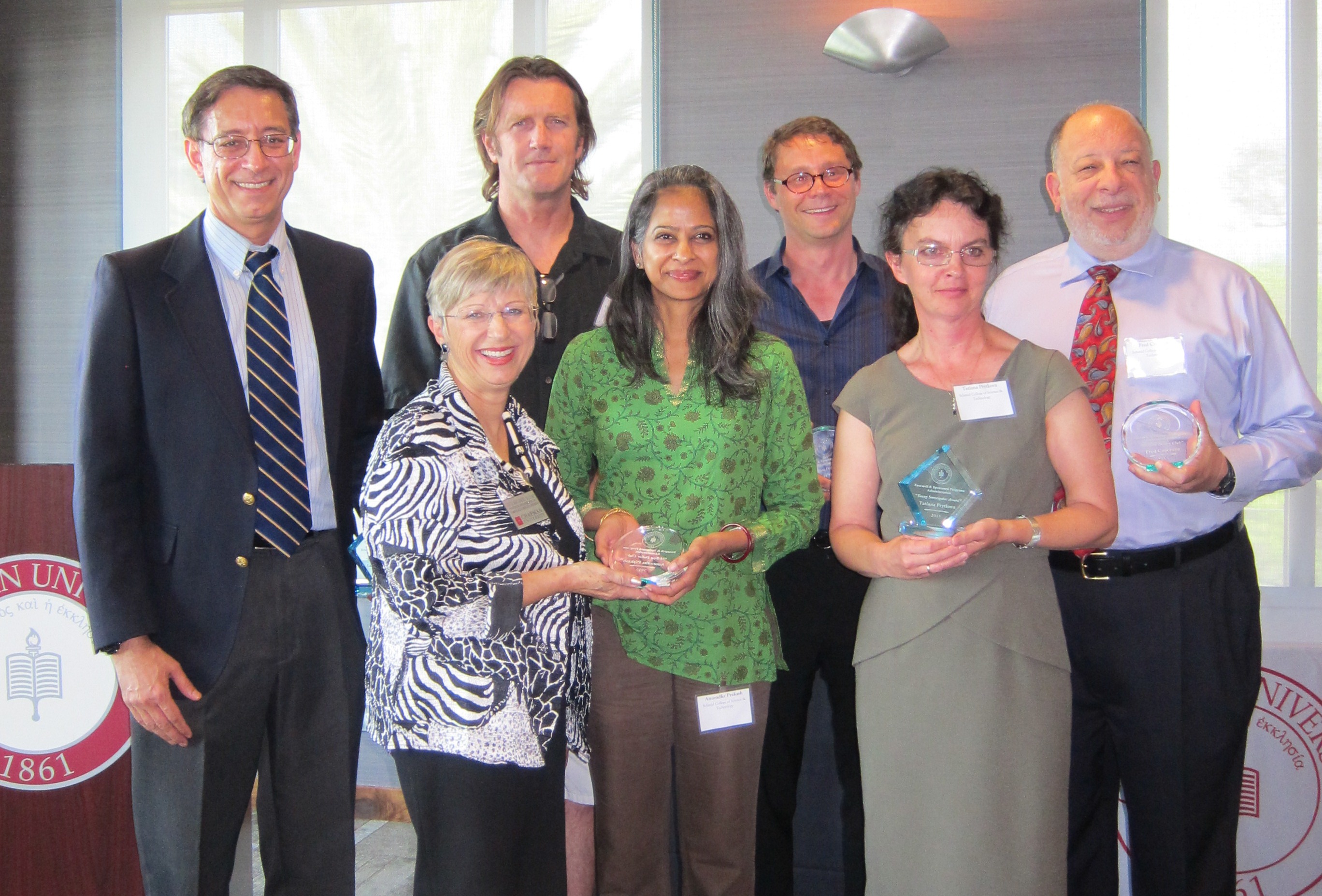 Recipients of awards presented at the Faculty Research Recognition Reception included, back row, from left, Laurence Iannaccone, Warren de Bruyn, Bart Wilson and Fred Caporaso; front row, from left, Judith Montgomery, Anuradha Prakash and Tatiana Prytkova.