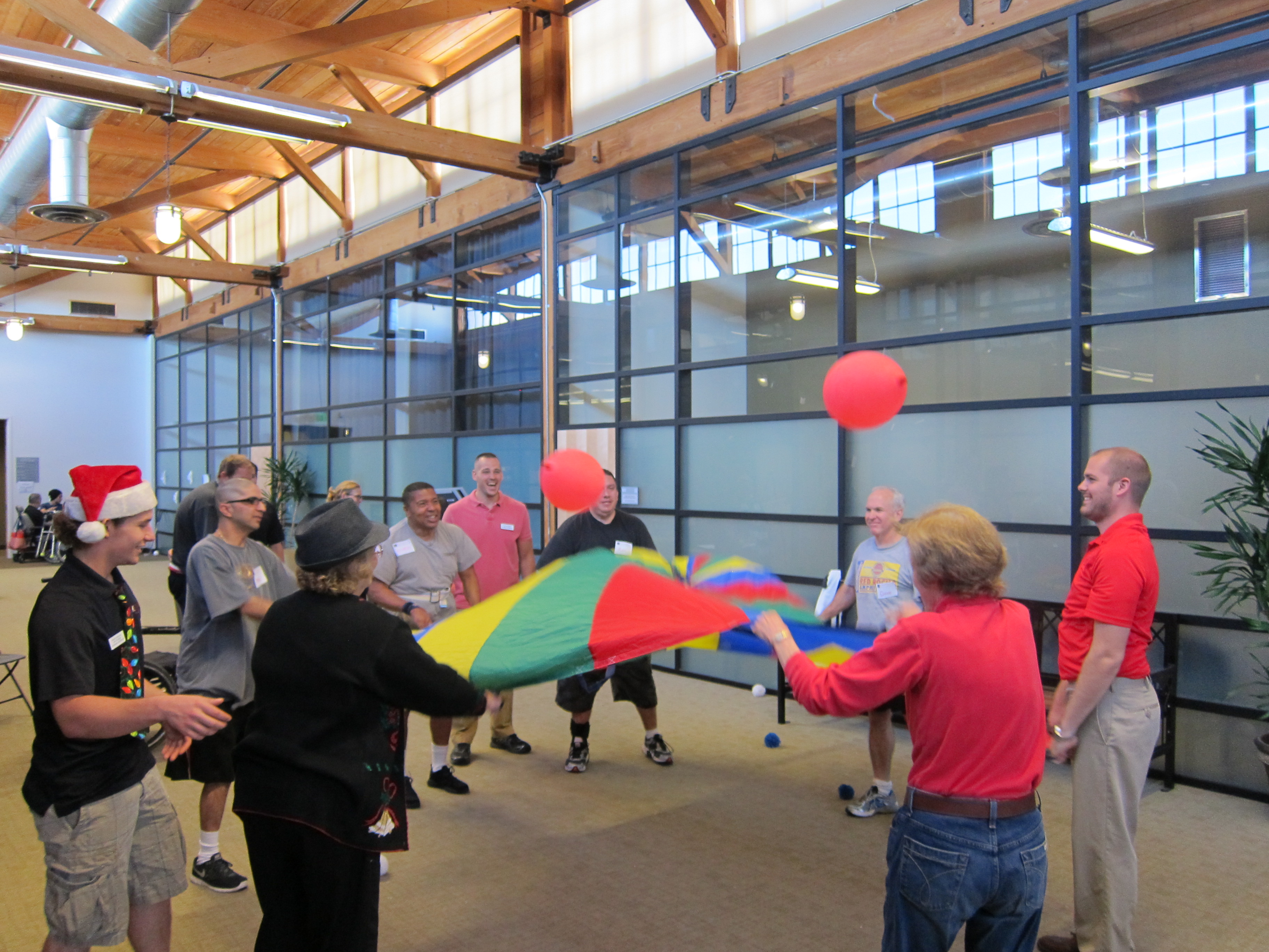 Stroke survivors at Chapman University's Stroke Boot Camp launch balloons off a colorful parachute as part of their physical therapy.