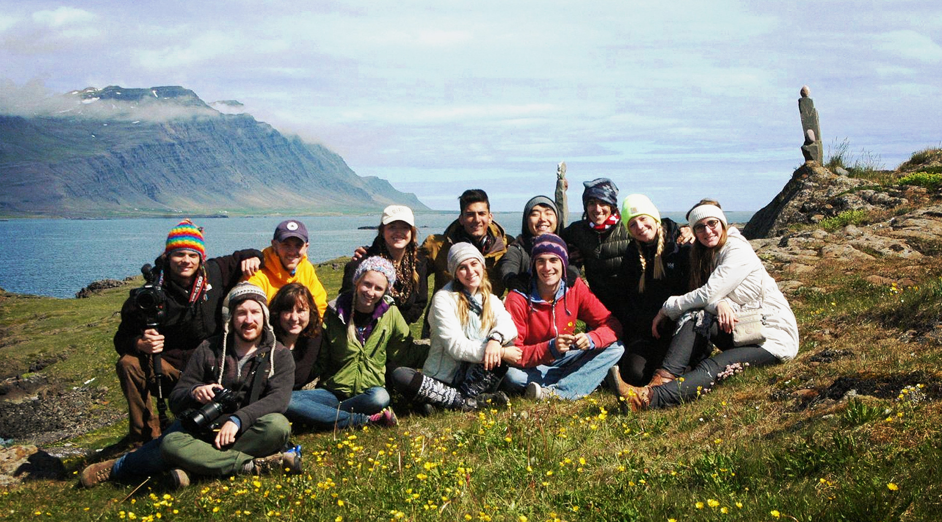 group of people on hill top sitting