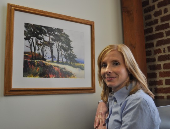 woman smiling with artwork