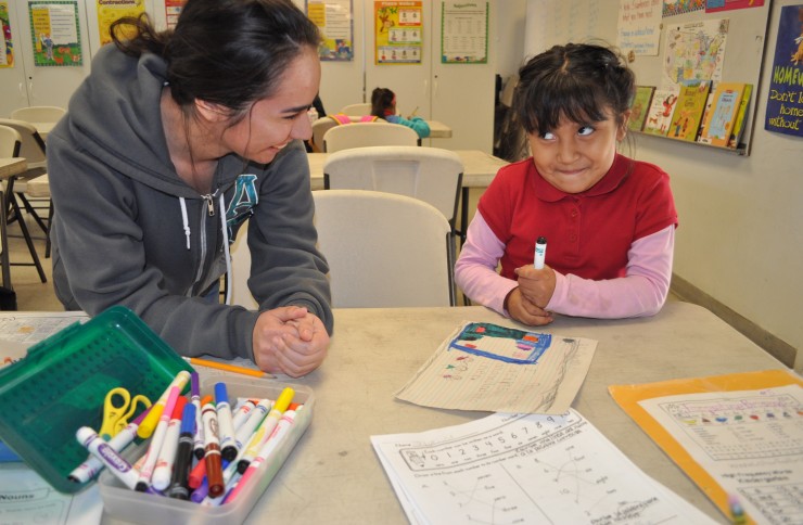 student helping young girl