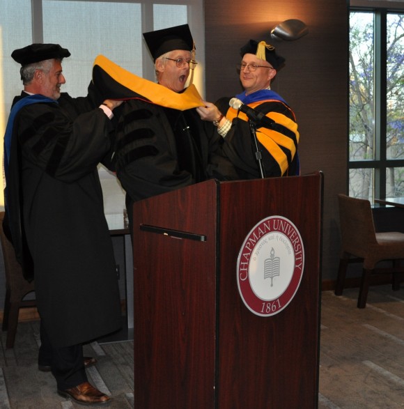 A playful Ted Nelson is conferred with the degree of Doctor of Science, honoris causa at by Chancellor Daniele Struppa and Douglas Dechow, Ph.D., science librarian and coordinator of the Intertwingled conference.