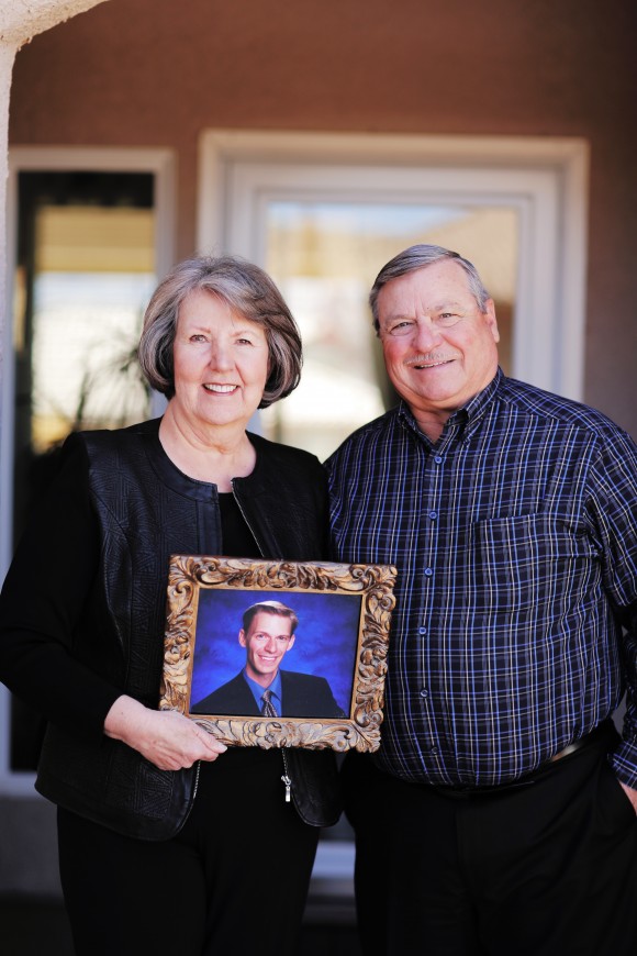 man and woman holding artwork