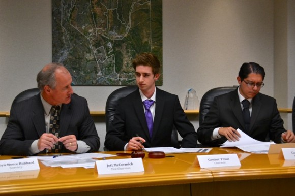 three people sitting at a desk