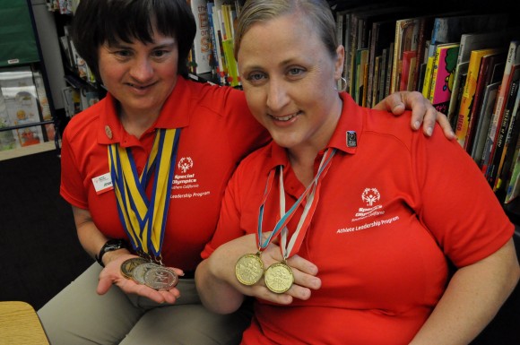 Jenny Skinner, left, and Debi Anderson, display a few of the medals they've won at Special Olympics.
