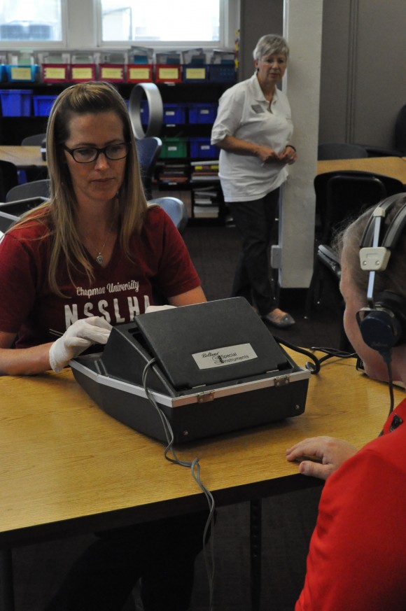 woman testing someone's hearing