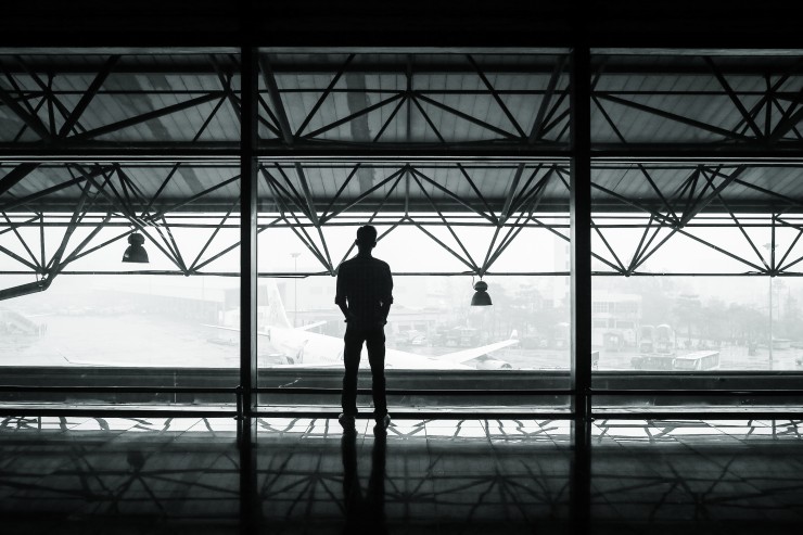 man looking at airplane