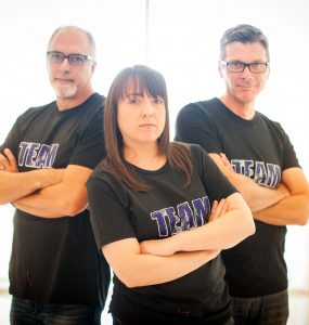 three people with arms crossed