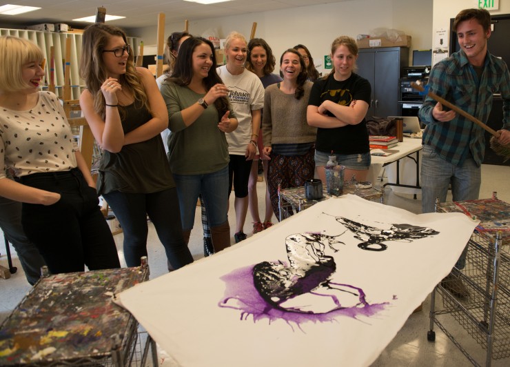 Chapman student works on an abstract painting.