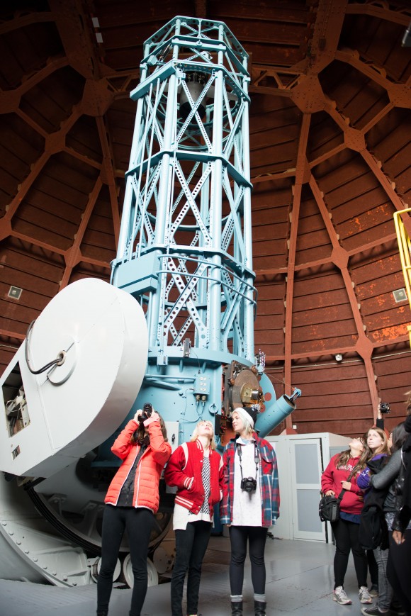 Students looking up at the telescope.
