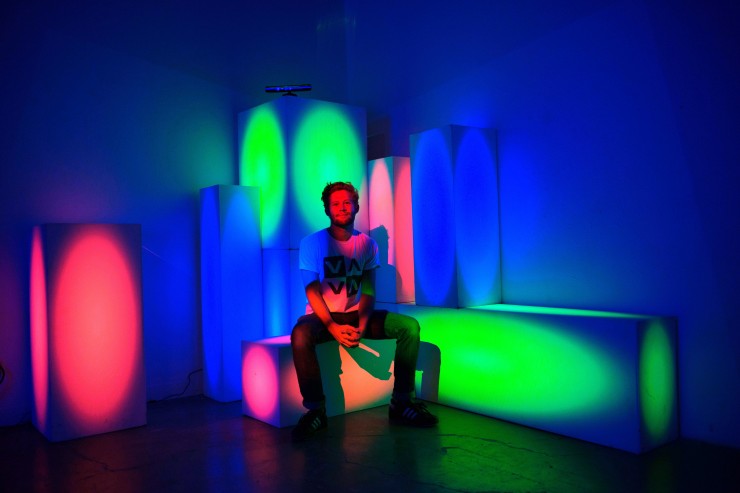 man sitting on colored blocks