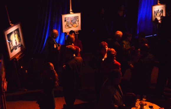 group in dark room looking at art