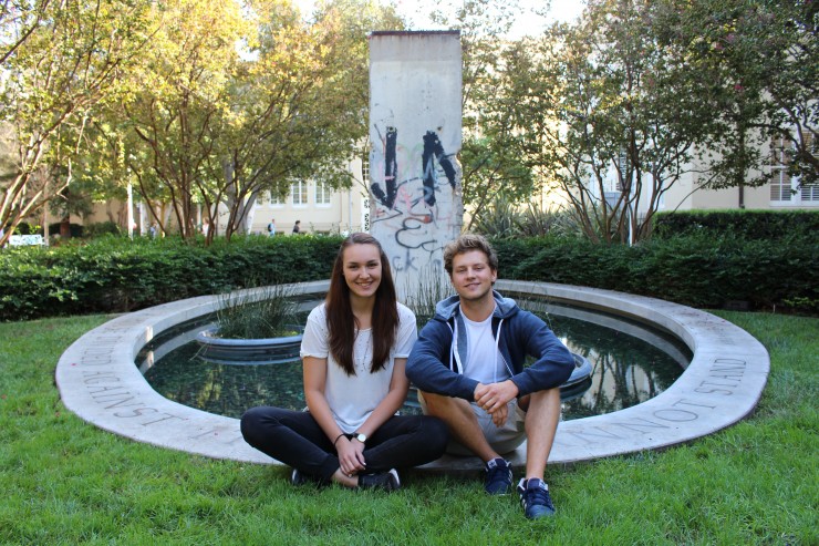 students smiling in front of Berlin Wall