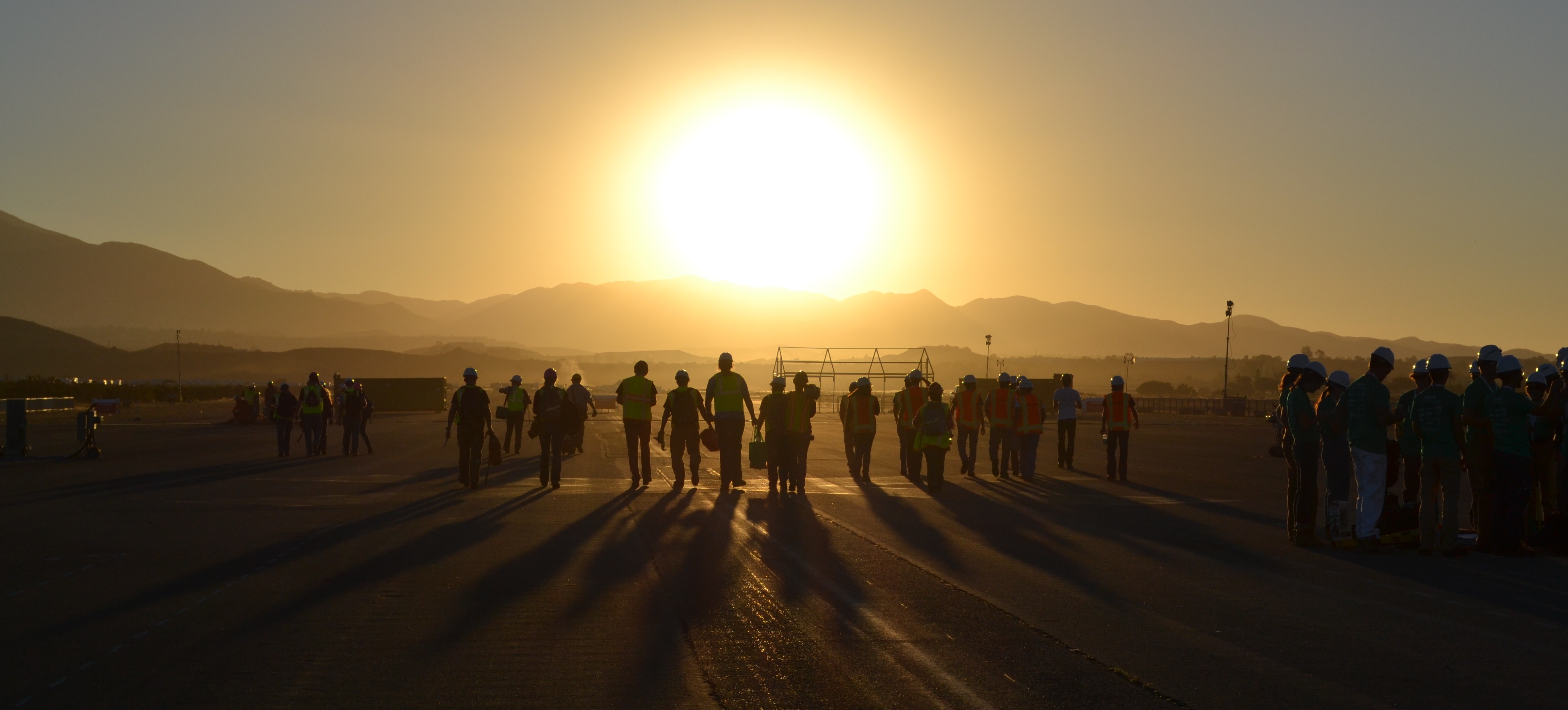 group of people walking into the sunset