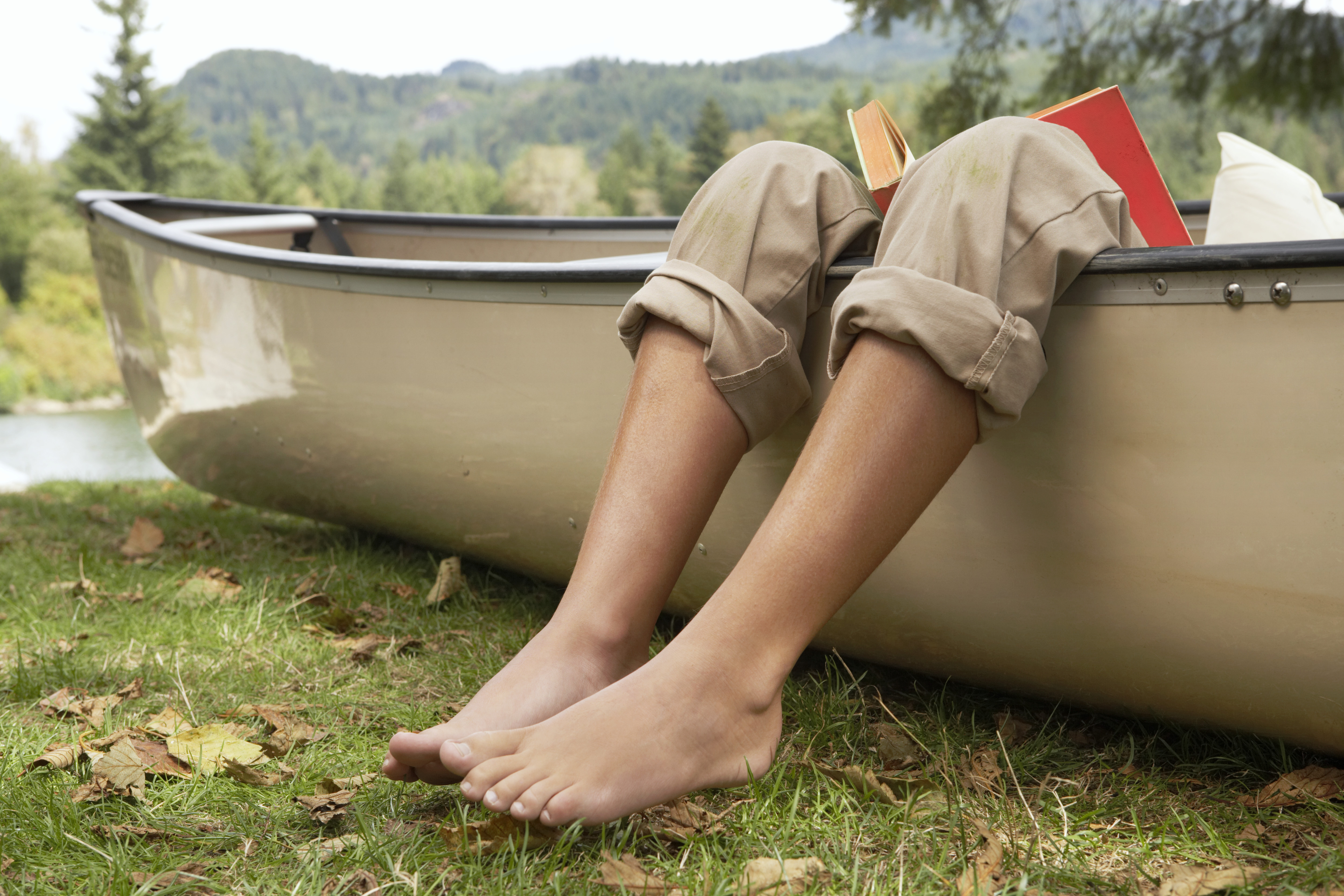 legs hanging out of a canoe
