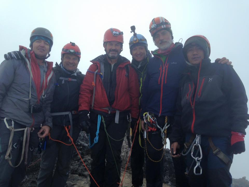 On the summit of Carstensz Pyramid, left to right: Todd Passey, Jim Doti, Scott Chapman, Adam Doti, Ralf Laier, unidentified.