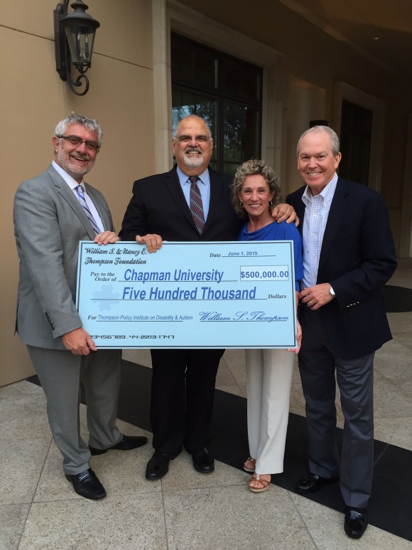 Left to right: Chapman Chancellor Daniele Struppa and TPI principal investigator Don Cardinal accept the first installment of a $3M gift from Nancy and Bill Thompson, establishing the Thompson Policy Institute for Disability and Autism at Chapman.