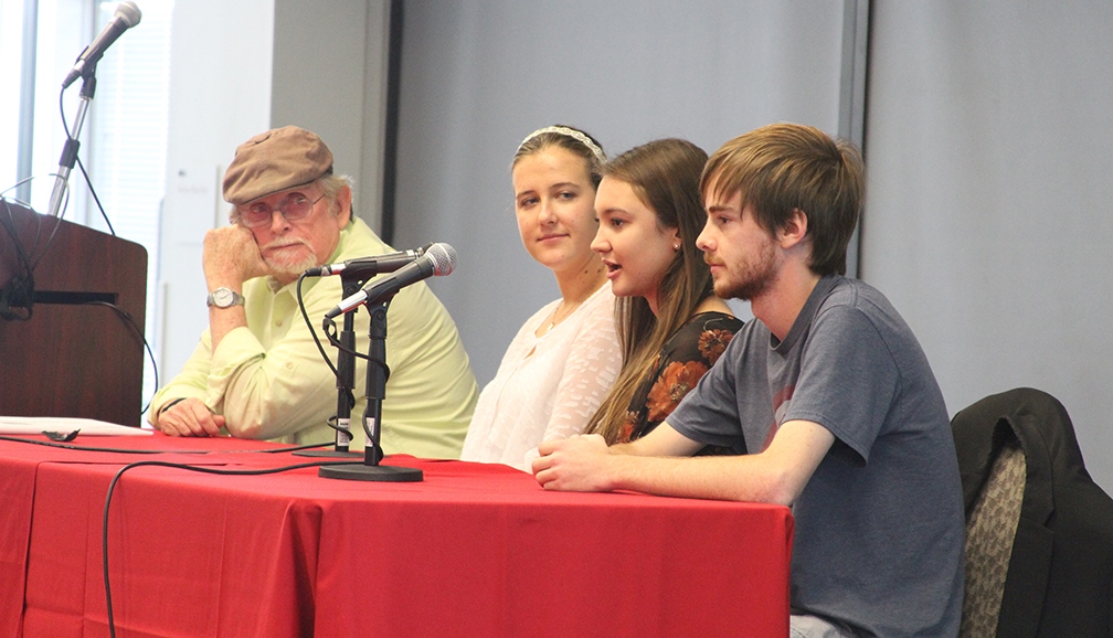 students and man speaking at table