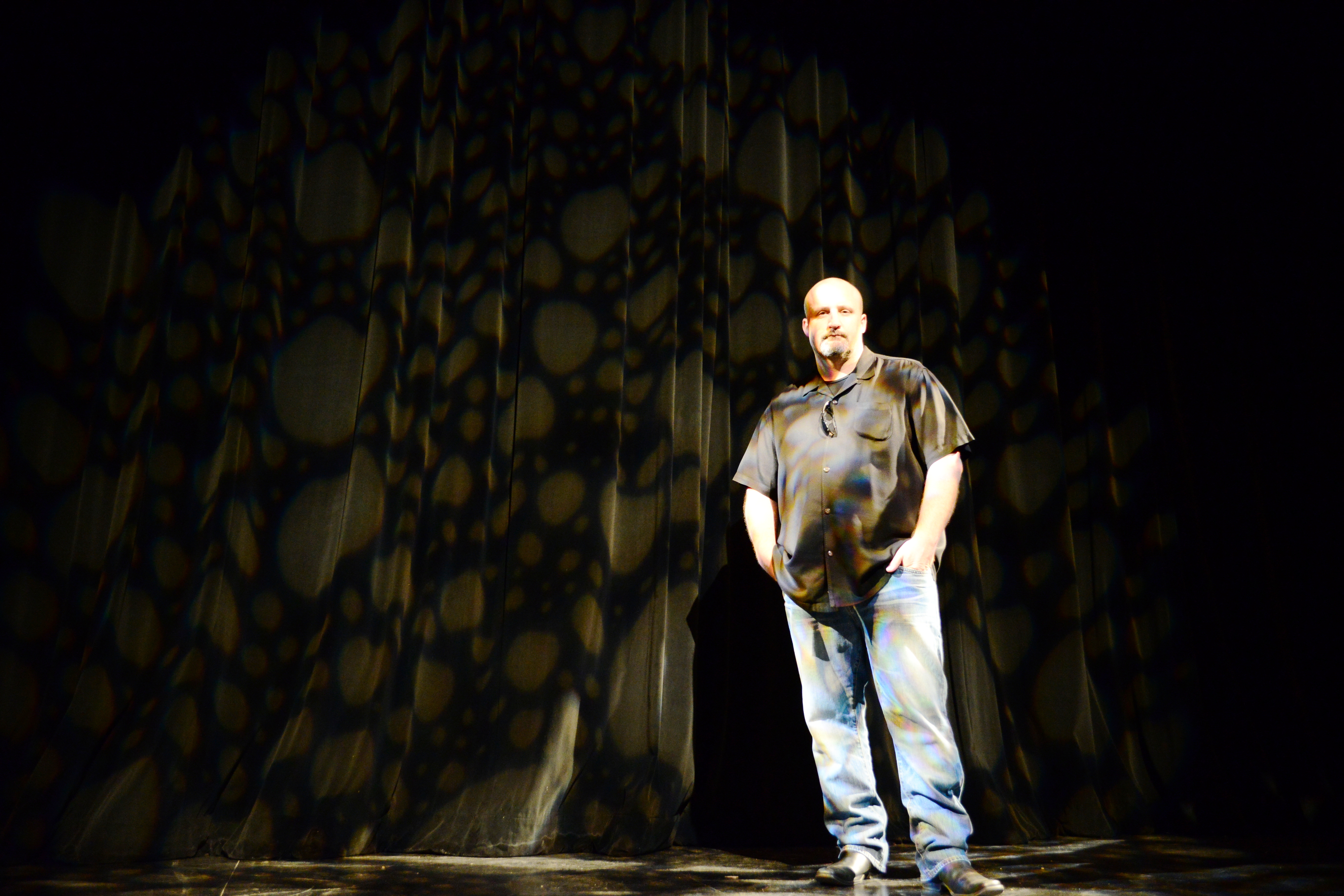 man smiling on stage