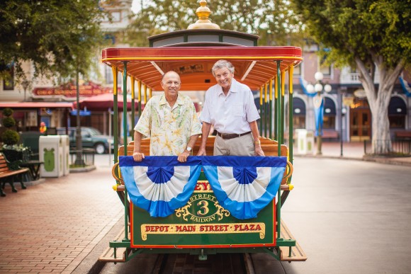 two men smiling on back of trolley