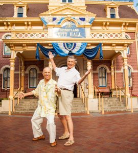 two men posing in front of Disneyland City Hall