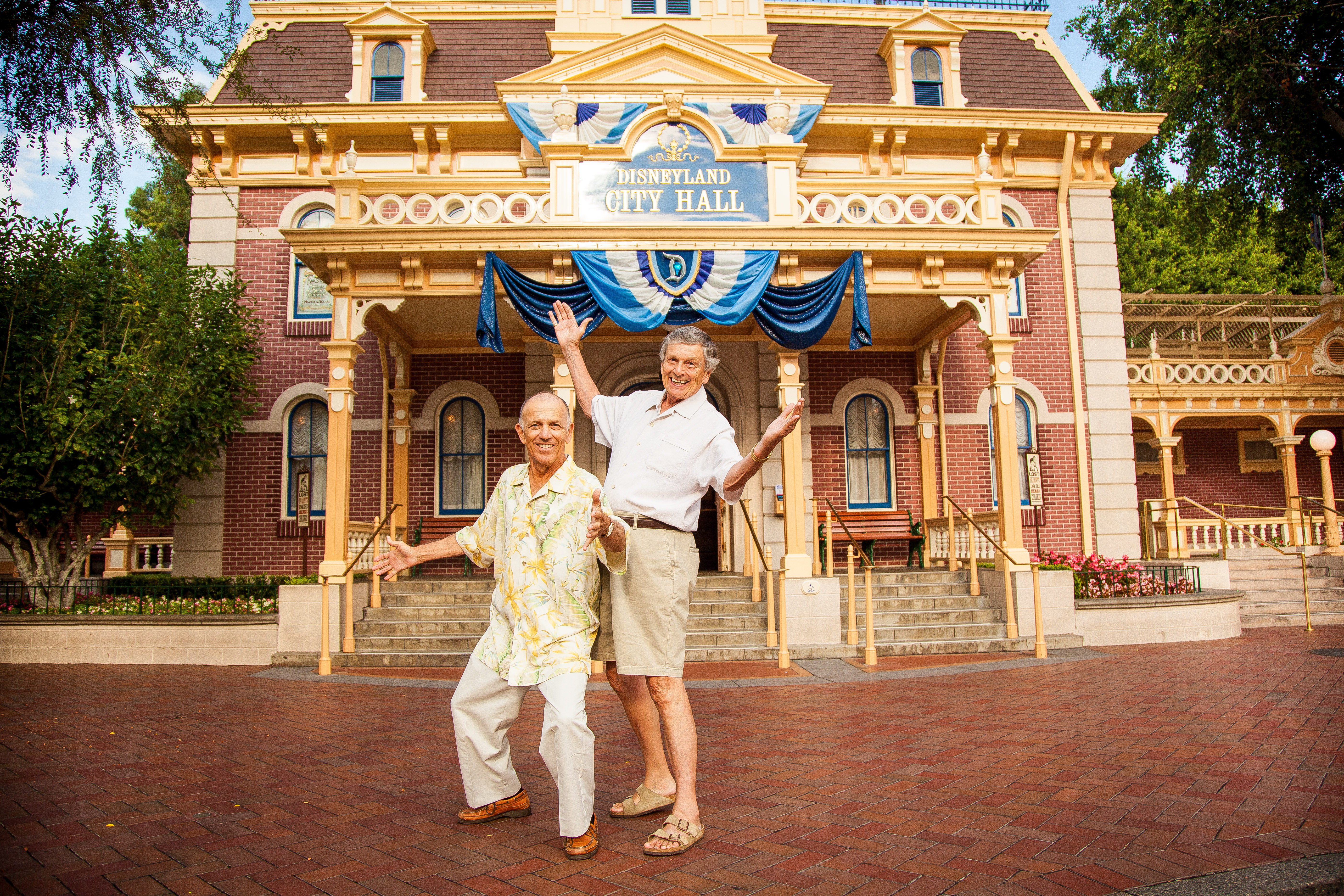 two men posing in front of Disneyland City Hall