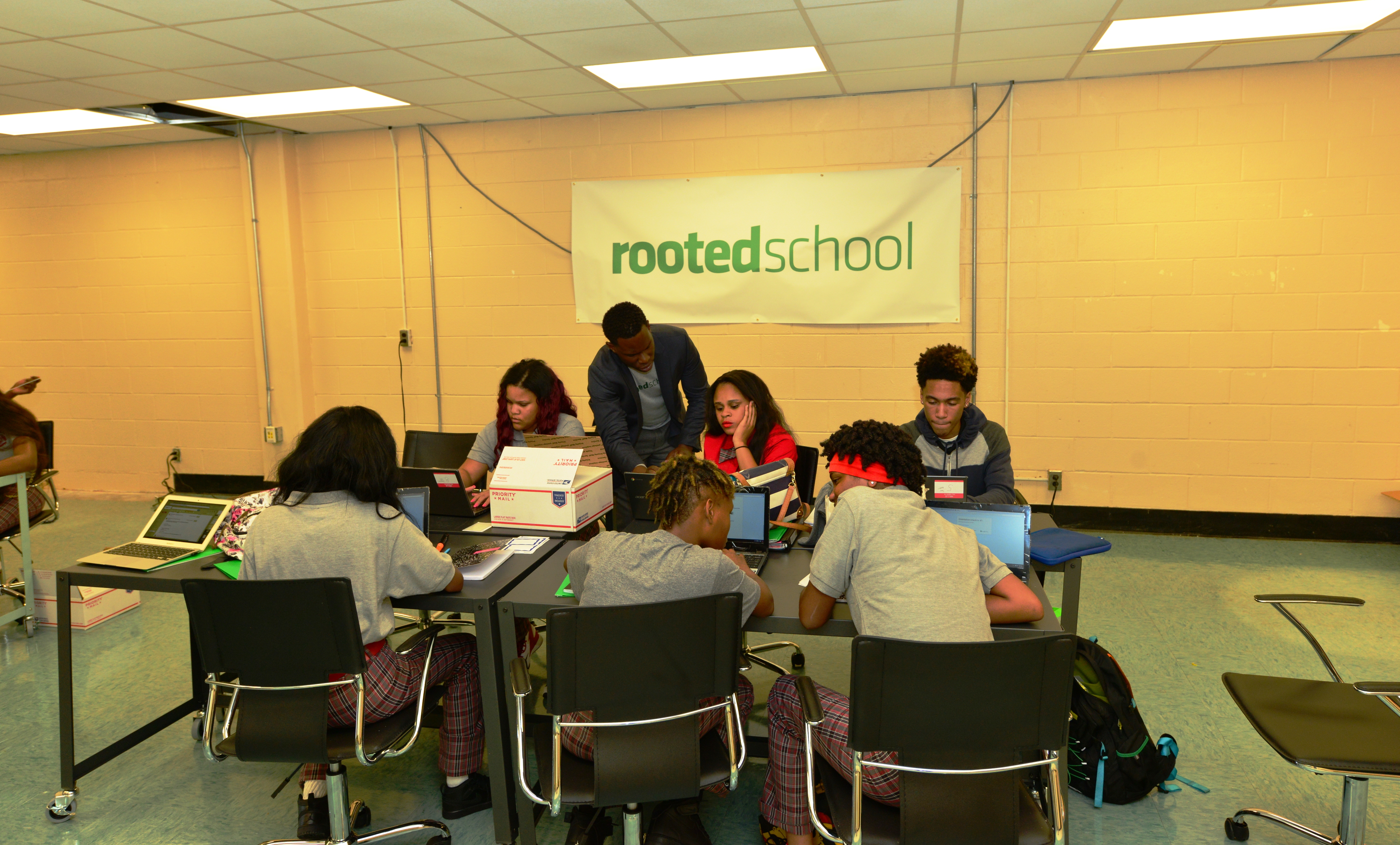 group at table on laptop computers
