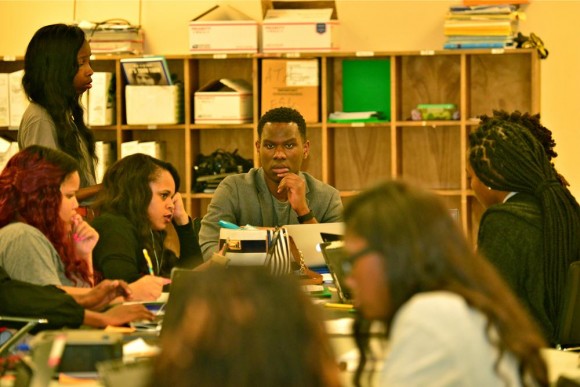 man at table with students