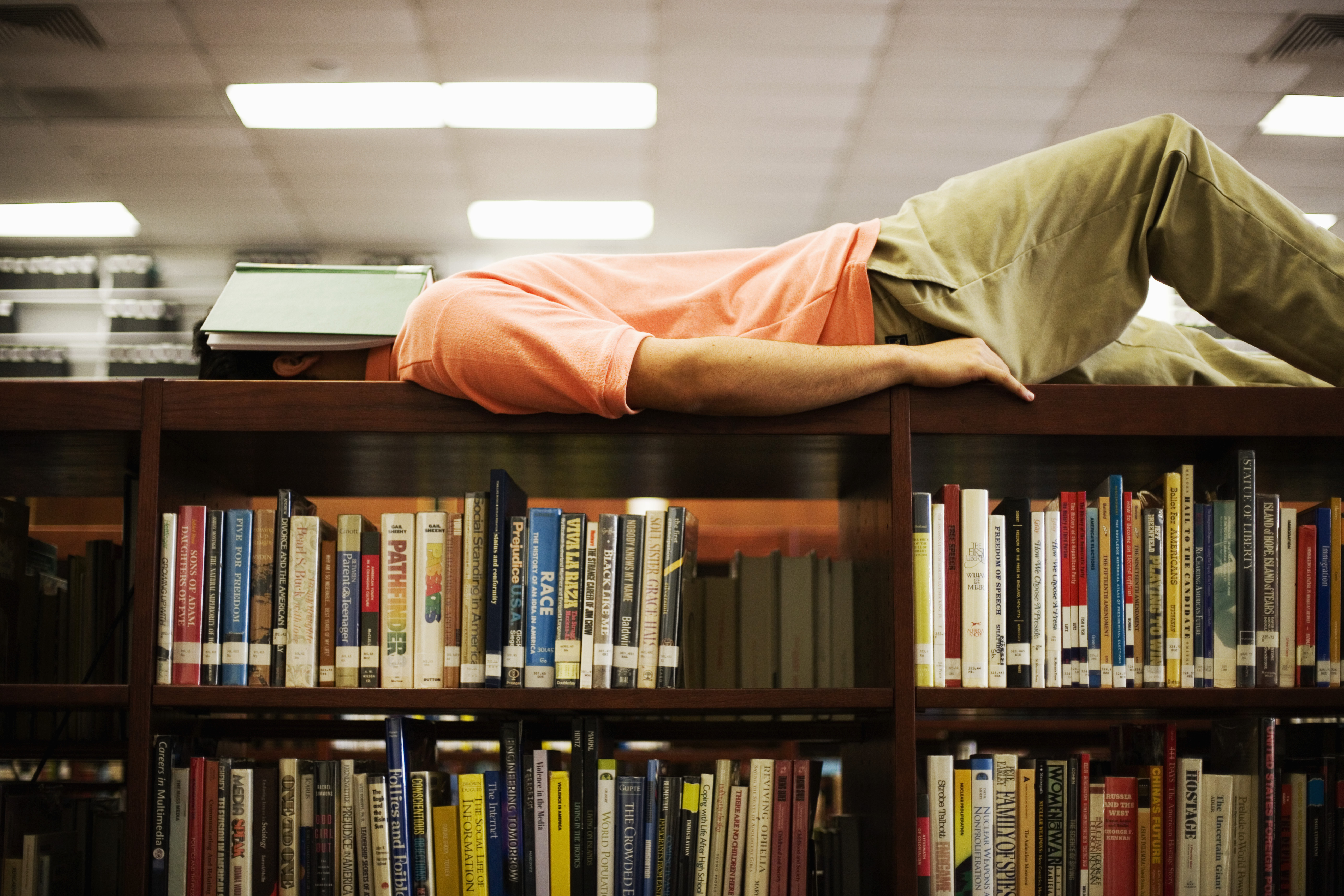 Young Man Falling Asleep with Book on Face