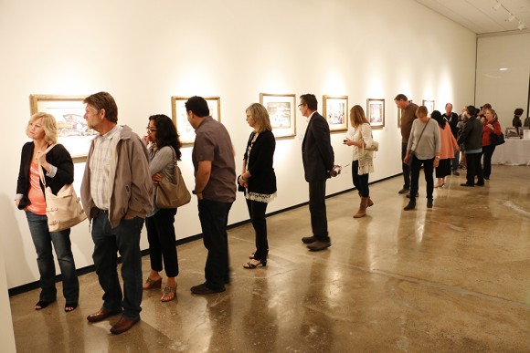 Crowds appreciating the paintings in the Hilbert Museum's opening exhibition, "Narrative Visions."