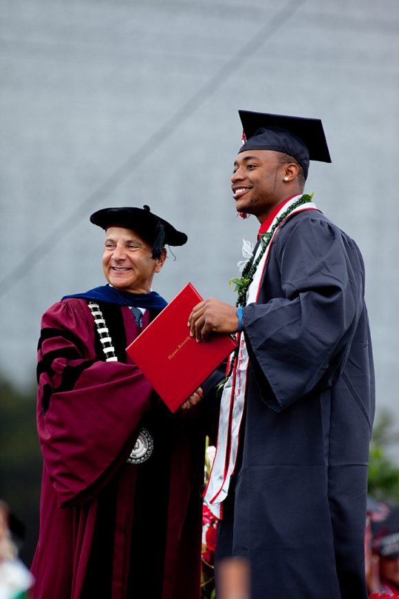 Chapman President Jim Doti congratulates a senior receiving his diploma. The 2016 ceremonies will mark Doti's final Commencement appearance as president; he steps down after 25 years and returns to the Chapman faculty this fall.