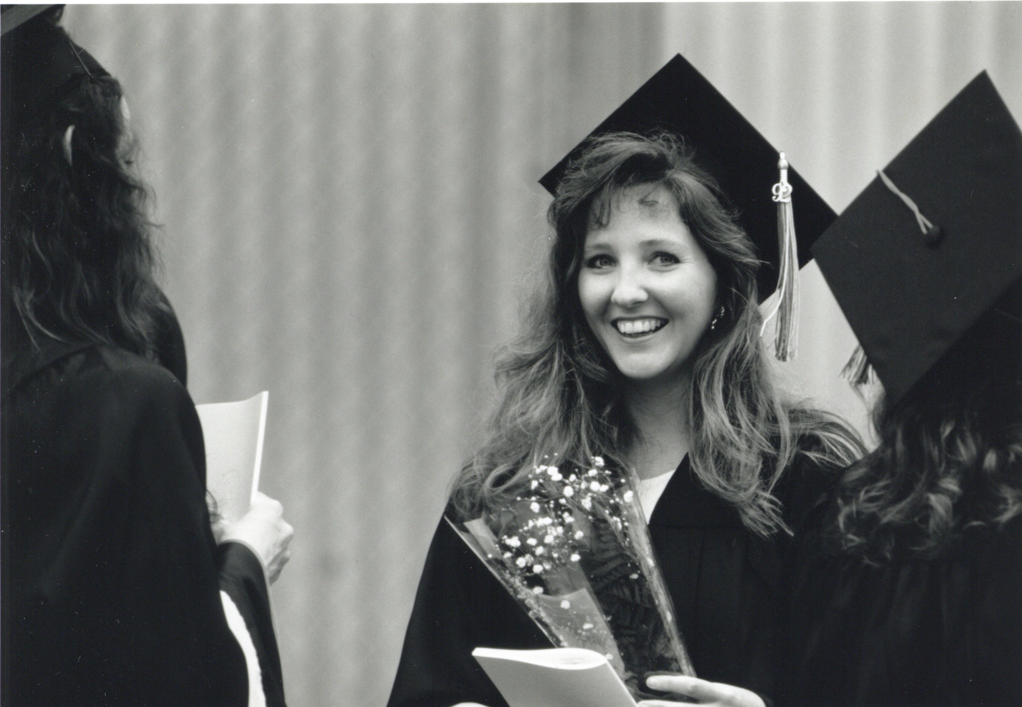 woman smiling in graduation gown