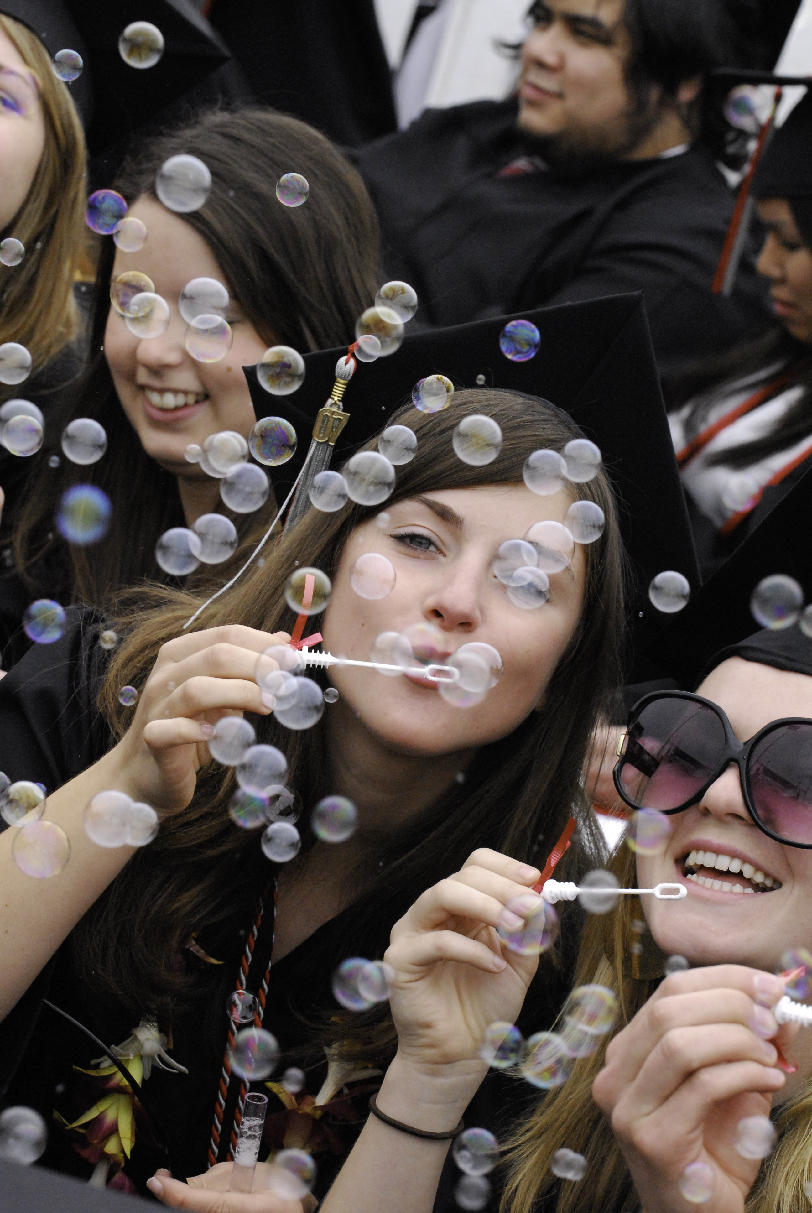 graduates blowing bubbles