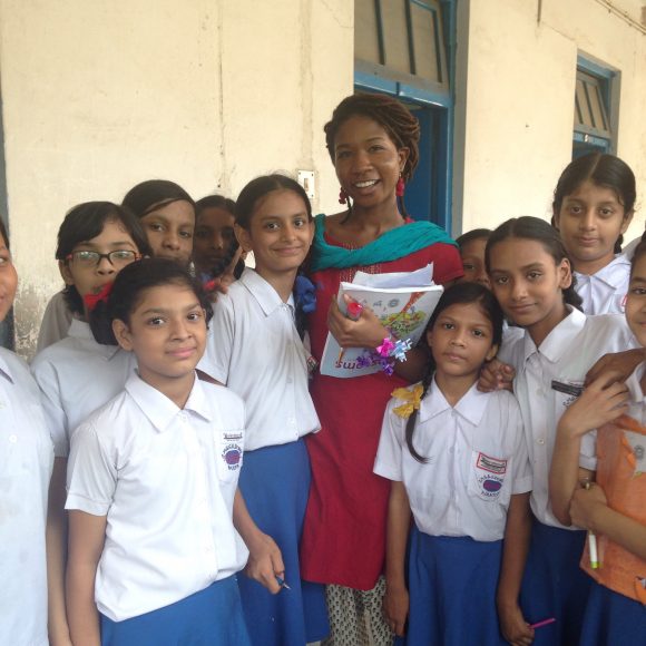 Woman surrounded by young students