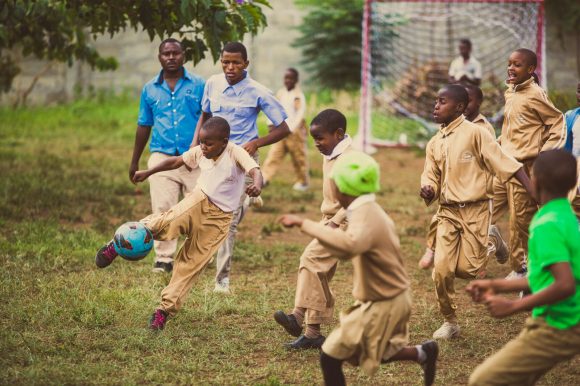 Small child kicking ball