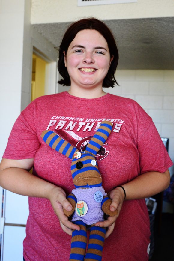 Young woman holding stuffed toy rabbit