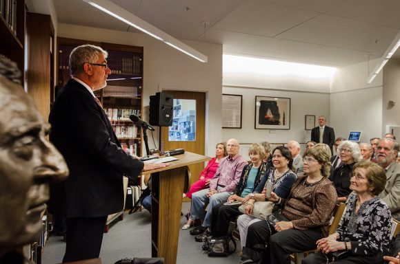 Chapman President Daniele Struppa speaks to an audience of friends, supporters, and Holocaust survivors and their families at the dedication of the Oskar Schindler Archive on Nov. 10. In front row, right, is Mila Page, 96, who was rescued by Schindler.