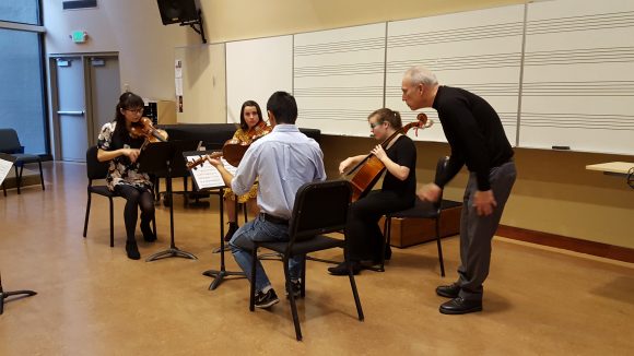 Kronos Quartet member Hank Dutt works with Chapman string quartet during his master class.