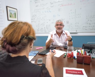 President Struppa talking at his desk