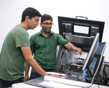 two students looking at computer