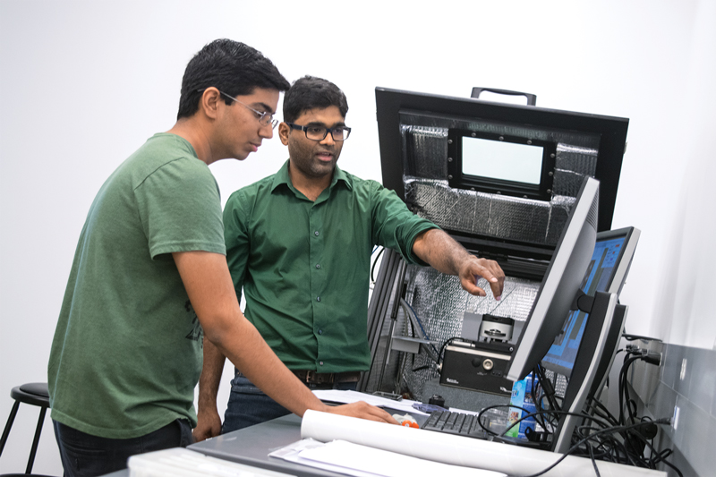 two students looking at computer