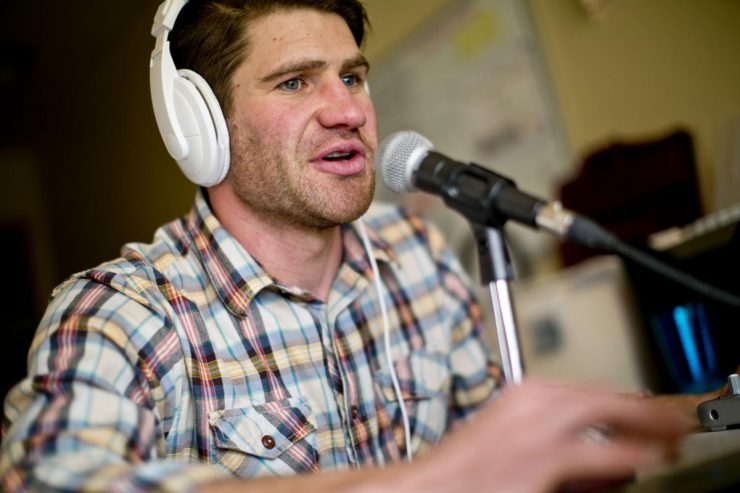 Paul Churchill '05 behind the microphone as he records his 'Recovery Elevator' podcast.