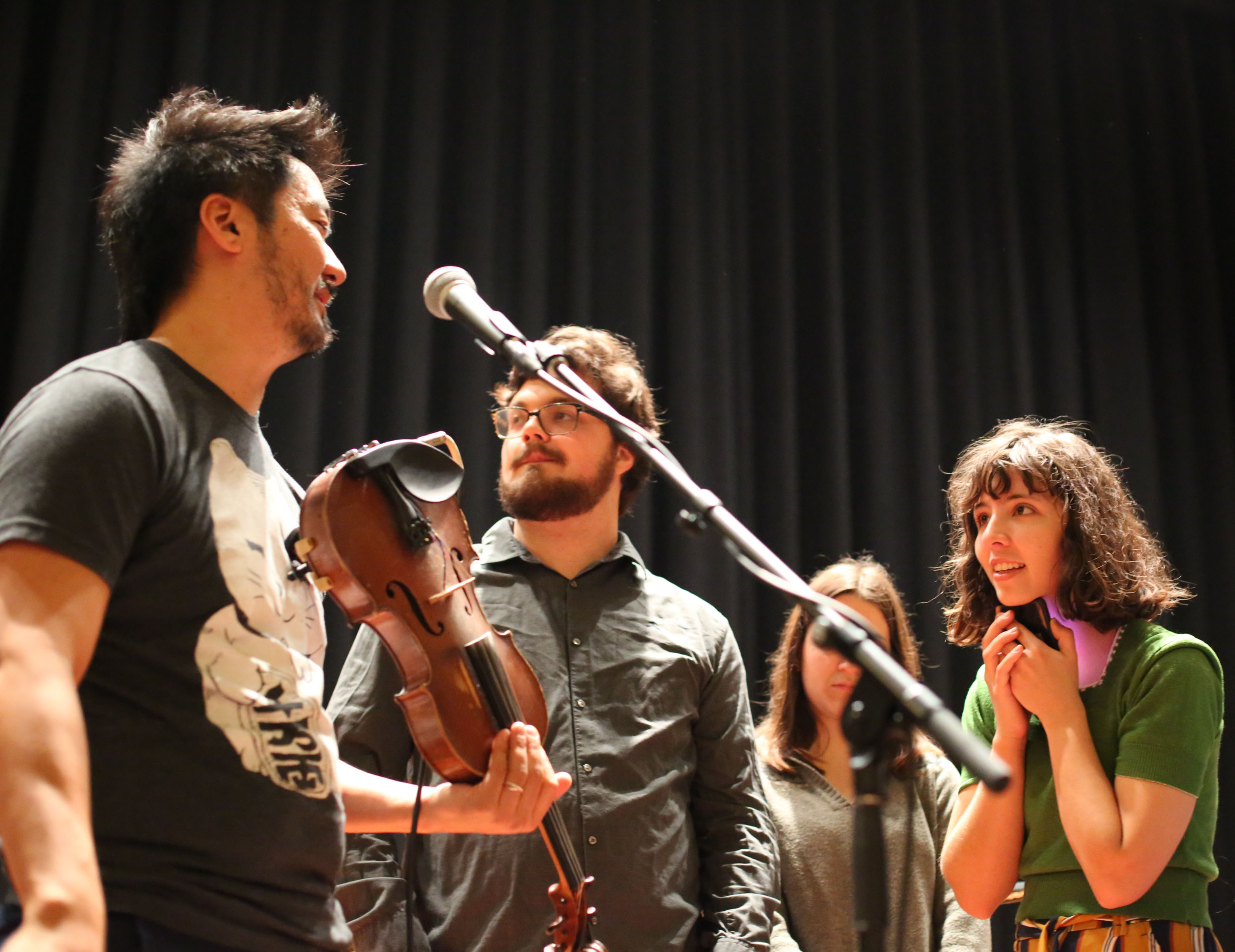 Bella Pepke, a cellist, listens intently to Kishi Bashi during the students' master class before his show in the Musco Center.