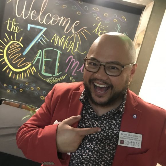 Smiling man pointing at nametag