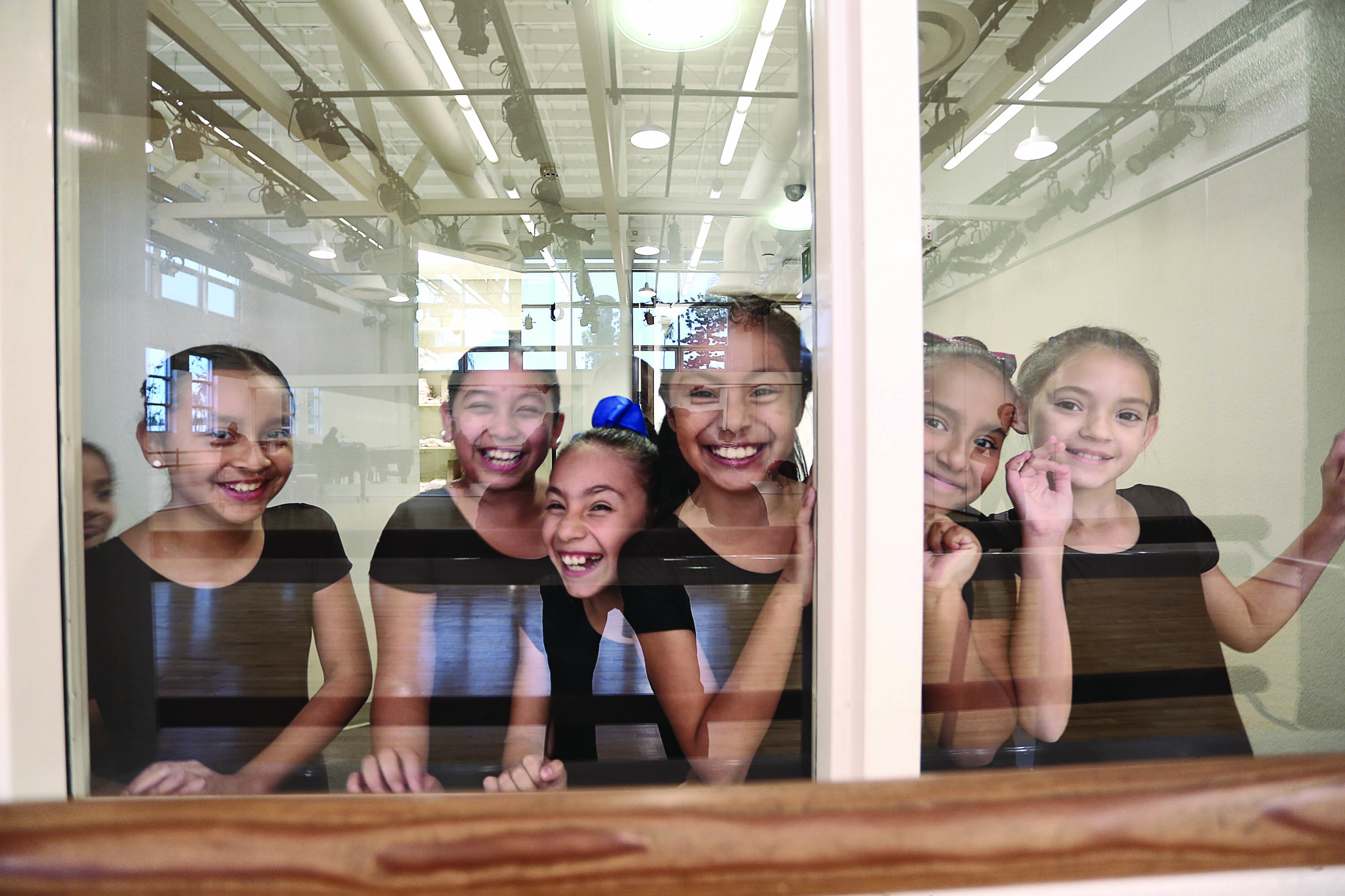 Student dancers from Wooden Floor gather in studio.