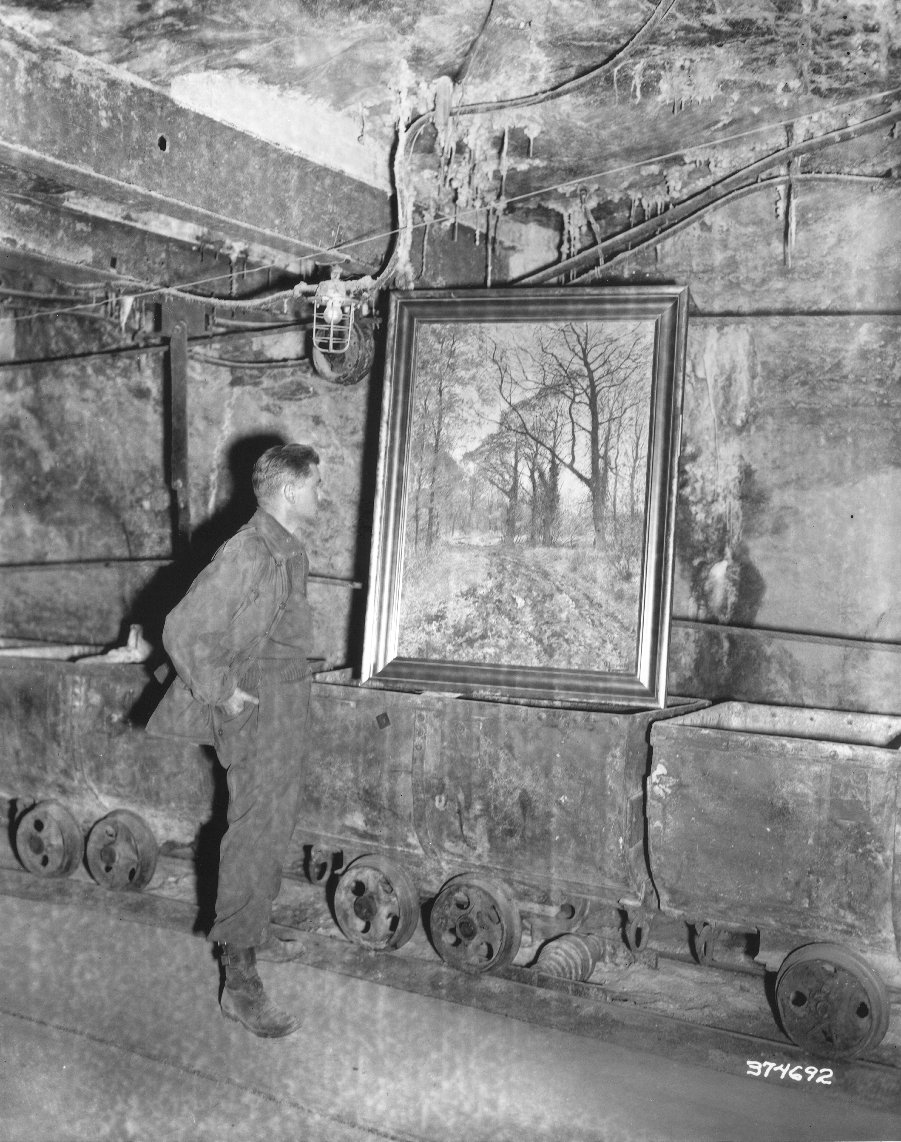 Soldier standing in front of looted painting